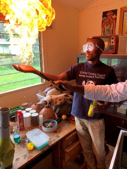 Participant showing how water prevents his hand from absorbing the heat from a flame