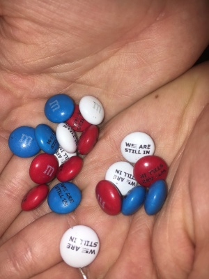 Chocolate candies with "We Are Still In" written on them