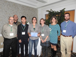 Conference attendees stand for photo