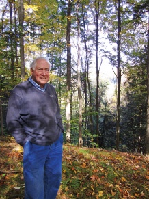 David Bandler stands in forest