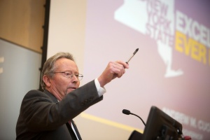 Ball speaking in front of screen