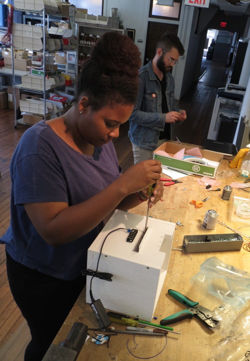 A student assembling a piece of equipment