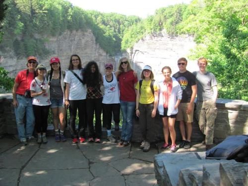 A group of interns pose in front of Taughannock Falls