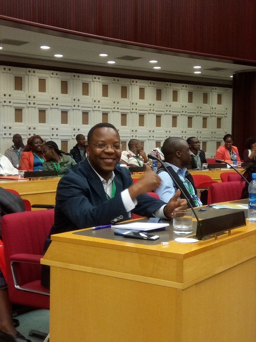 A man sitting at a desk at a conference
