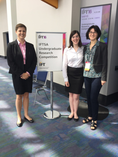 Three women standing together and smiling