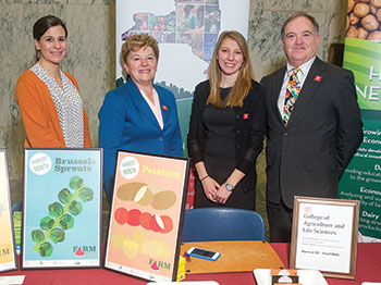 Four people stand together for a group photo