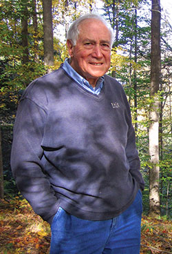 A man stands outside in a forest