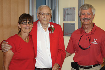 Two men and a woman stand together for a photo