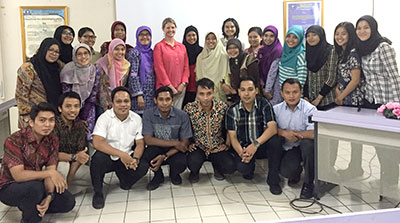 A group of people stand together for a photo