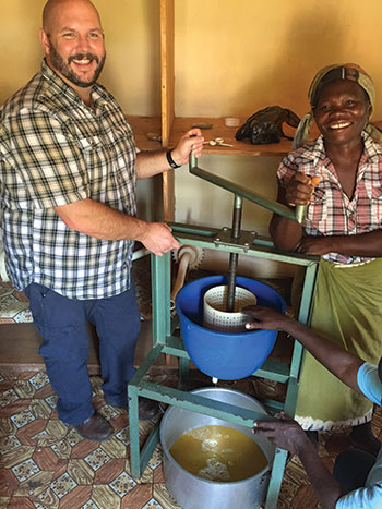 A man and a woman make juice using a juice extractor