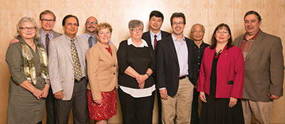 A group of people stand together for a photo