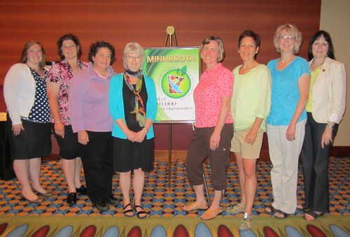 A group of women stand together and pose for a photo