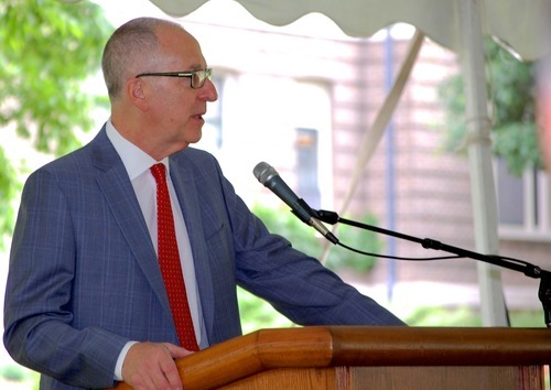 A man stands at a podium and speaks
