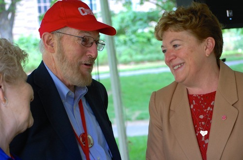A group of people stand together and talk