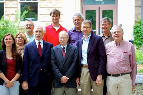 A group of people stand together for a photo