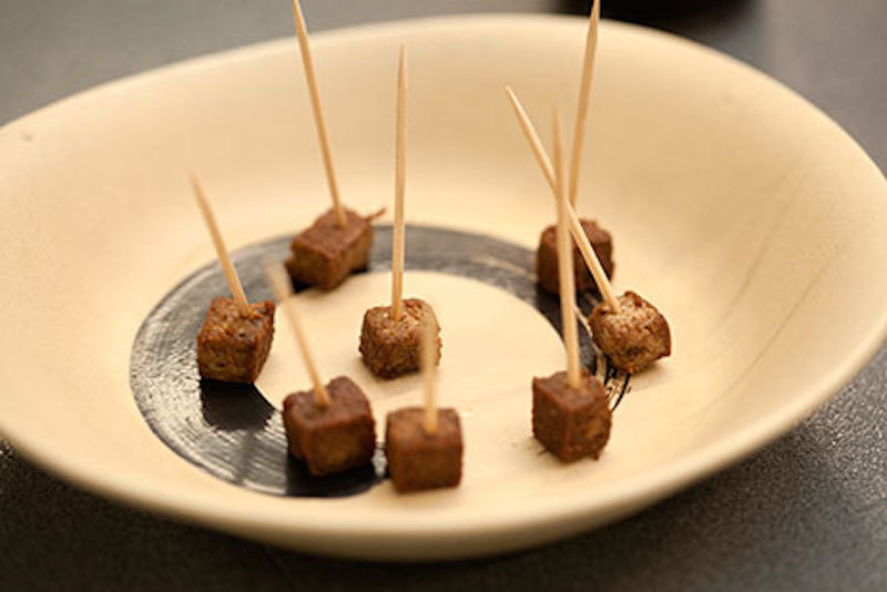 Mealworm-based meat on a plate with toothpicks