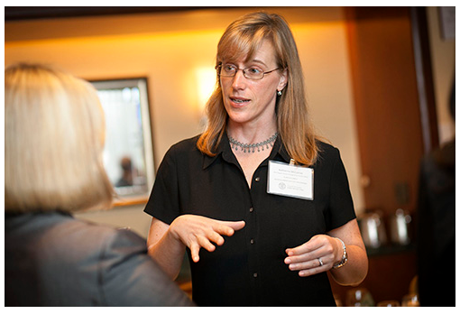 Two women speak together