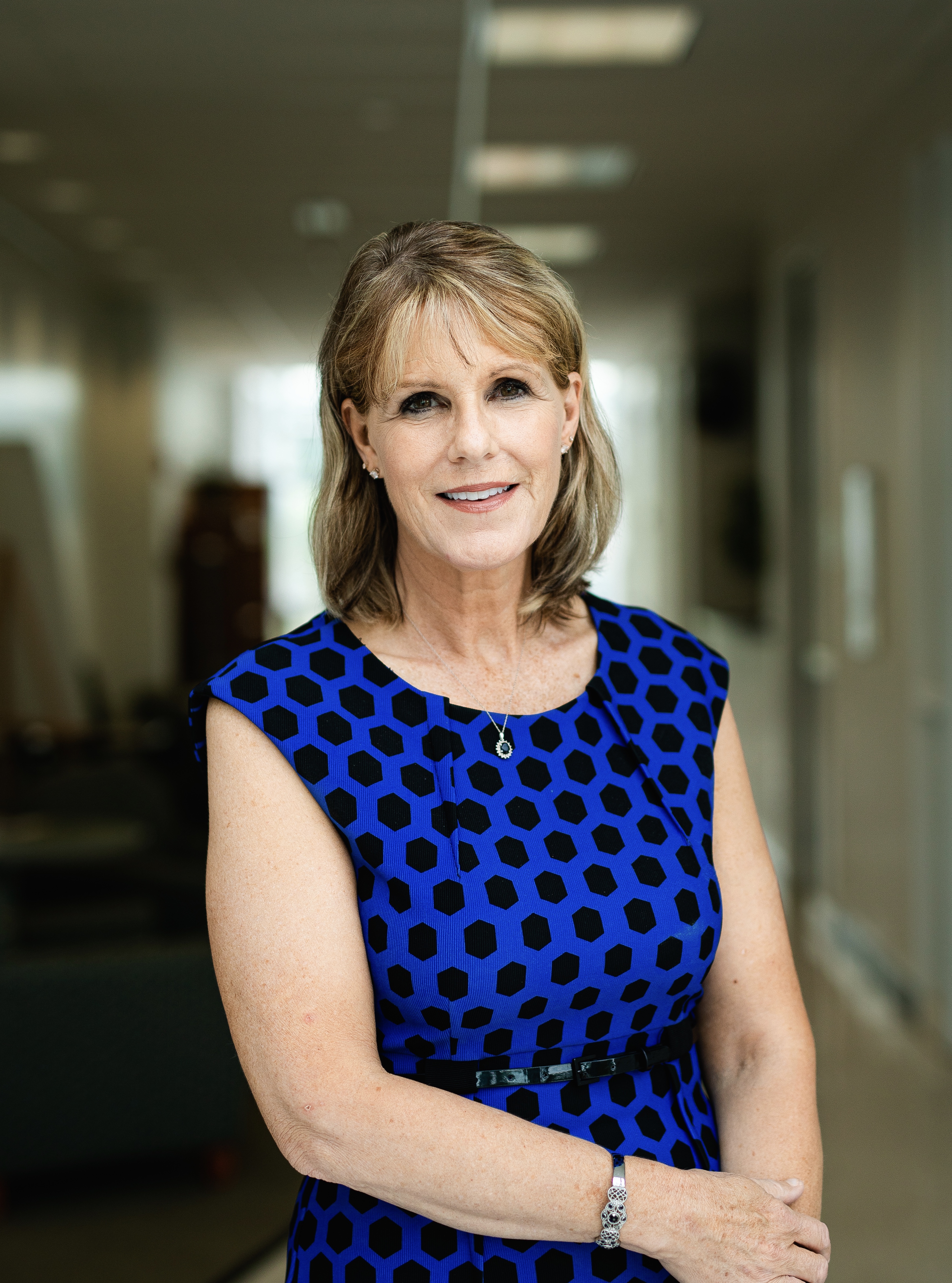 A woman stands in a hallway 
