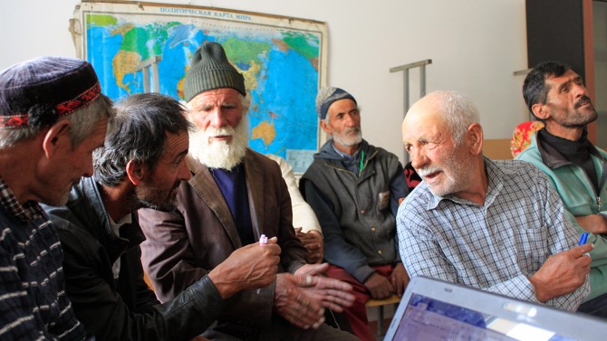 A group of men having a conversation indoors.