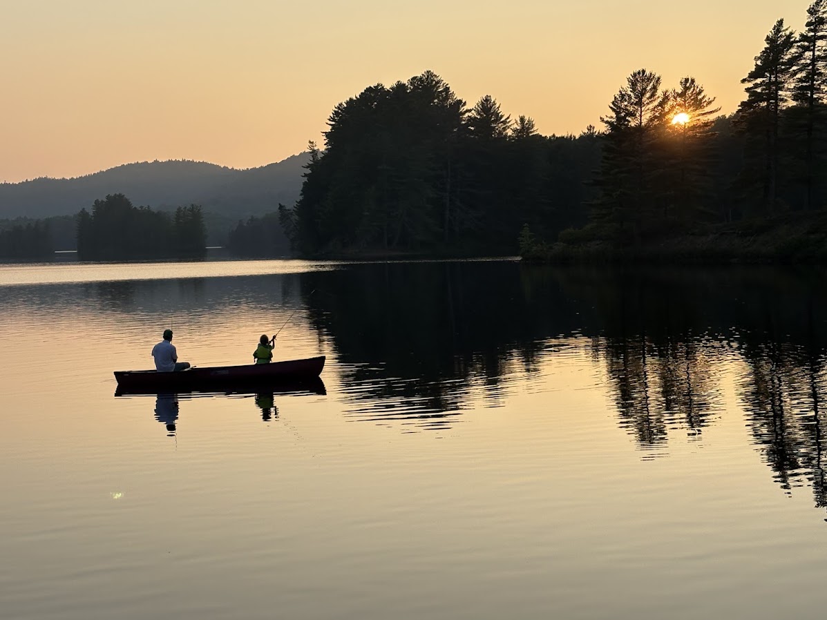 Patrick Murphy in a canoe at sunset with family