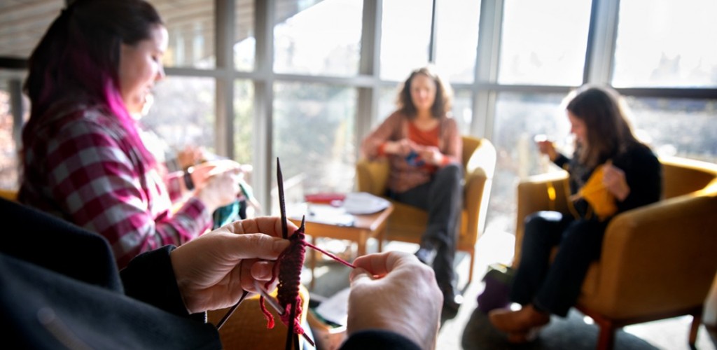 Volunteers sitting in a circle and kitting