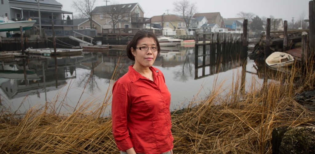 Helen Cheng stands near shoreline