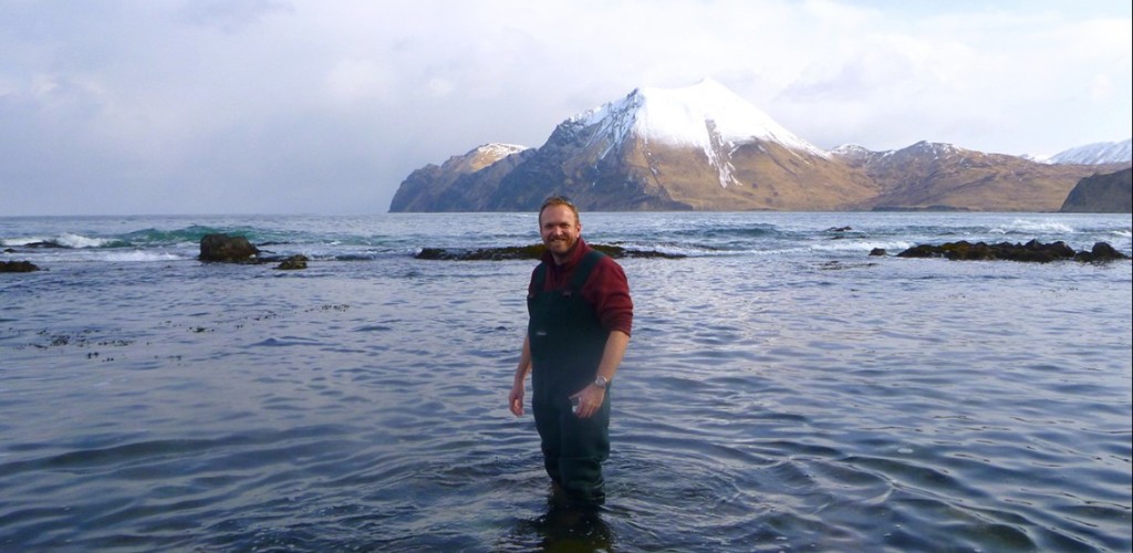 an Hewson standing in water in the Aleutian Islands, Alaska