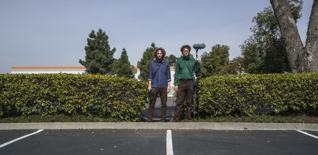 Chris Hoff and Sam Harnett standing with equipment