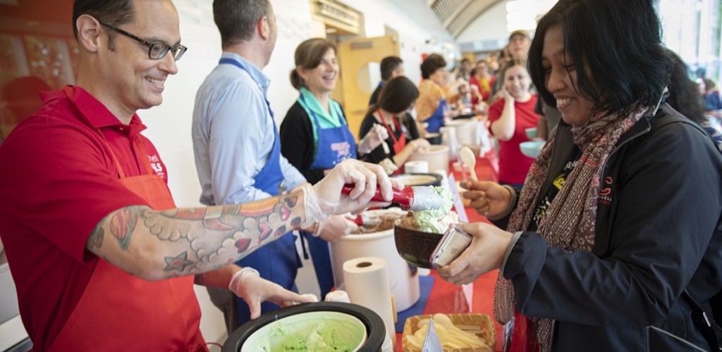 Volunteers serve ice cream to students