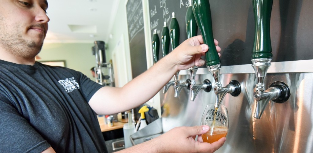 Man pours beer from a tap