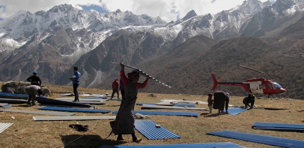 the people of Langtang carrying CGI sheets