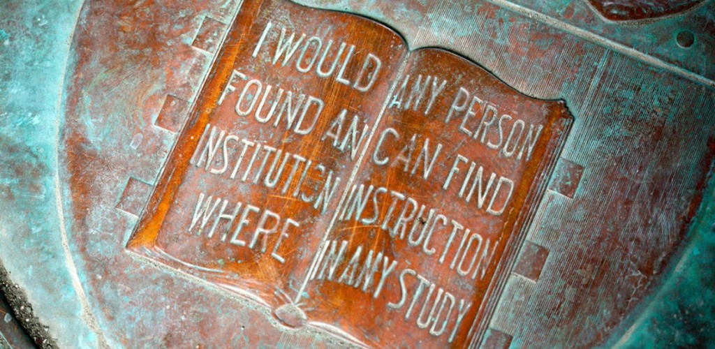 Cornell's motto carved in an image of a book