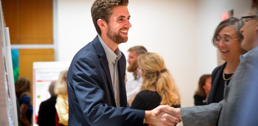 Intern shakes hands with employer