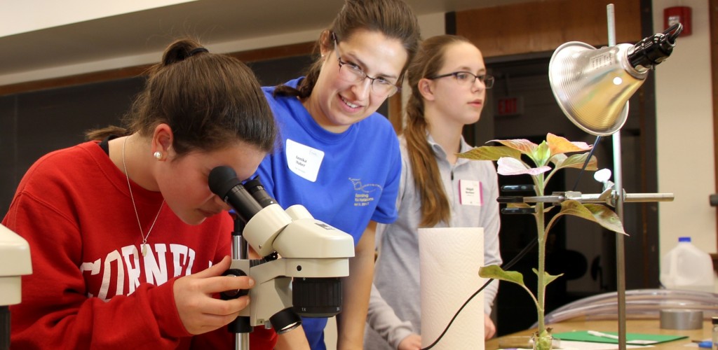 middle schoolers participating with microscope
