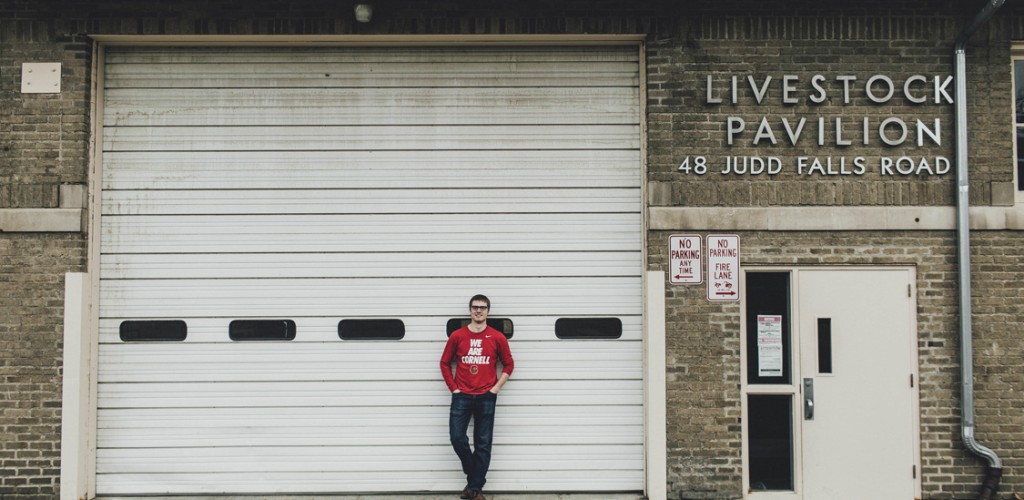 Conor McCabe stands outside Livestock Pavilion building