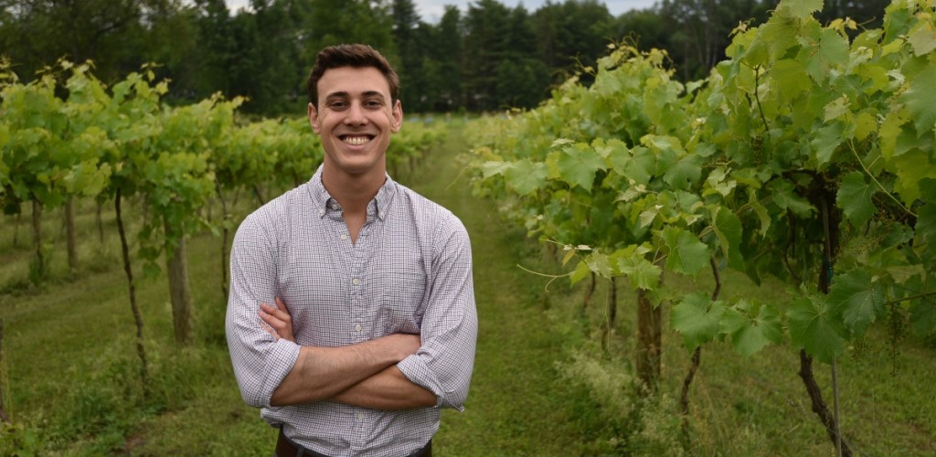 Student stands in a vineyard