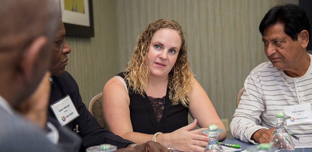 Farmers hold a discussion around a table