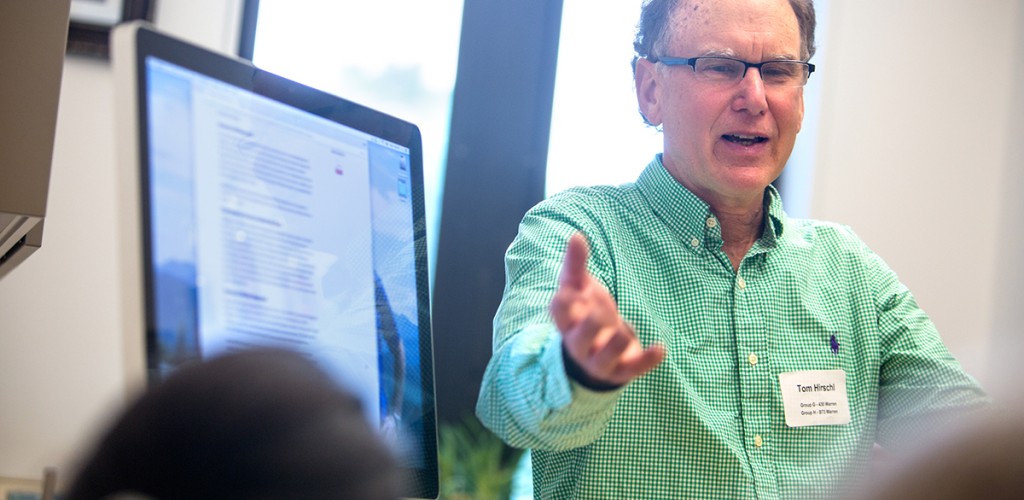 Tom Hirschl demonstrating his poverty calculator to other team members