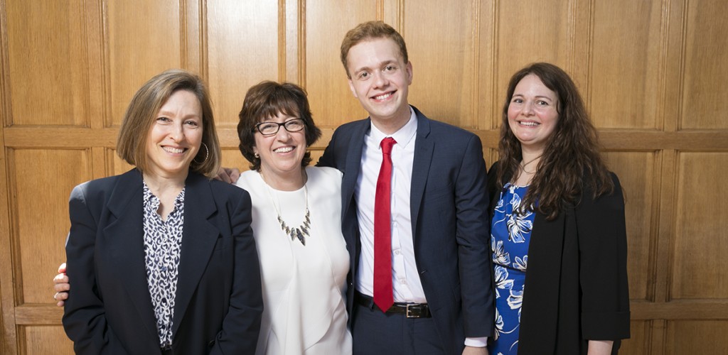 Kevin Kowalewski ’17, center, is joined by, from left, Dawn Chutkow, visiting professor of law; Cornell President Martha E. Pollack; and his mother, Julie Kowalewski