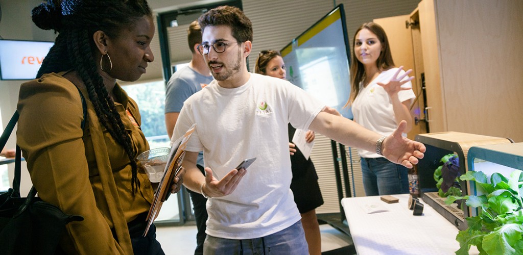 student shows his project to other student