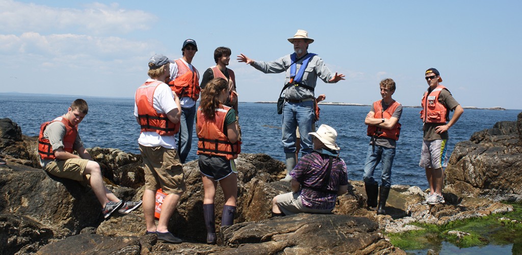 Jan Factor talks to student overlooking the ocean