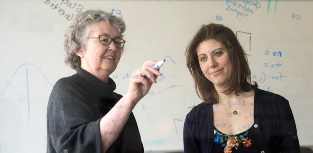 professors writing on clear wall