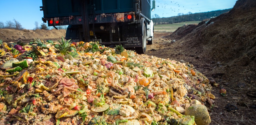 A truck dumps Cornell dining hall food waste at the university’s composting facility