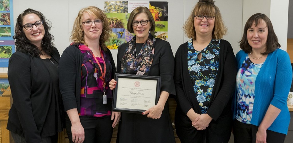 Cheryl Gombas stands with colleagues