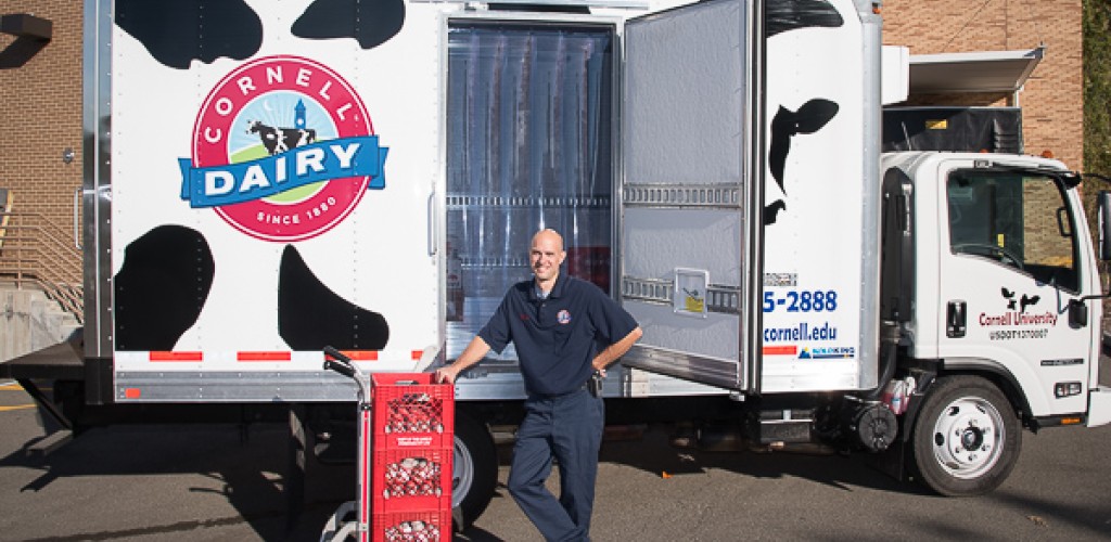 Chris Bush stands in front of a Cornell Dairy truck