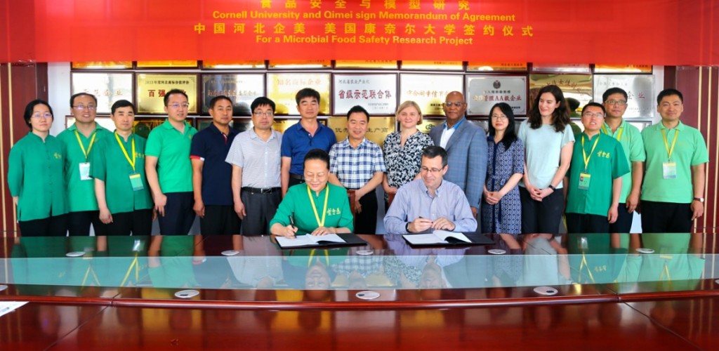 Long table of leaders gather around signing a proposal 