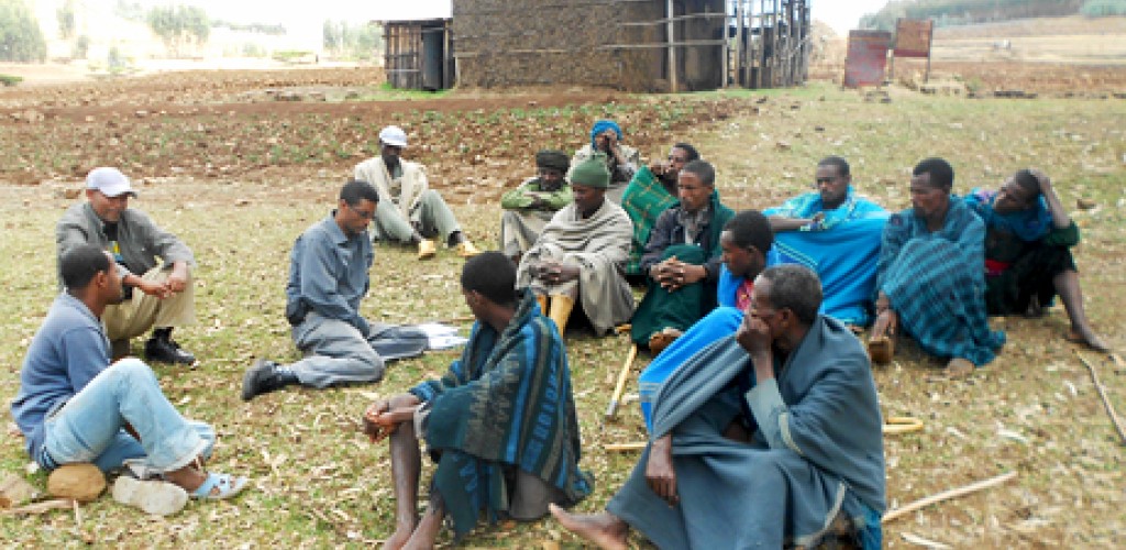 A group of people sit on the ground