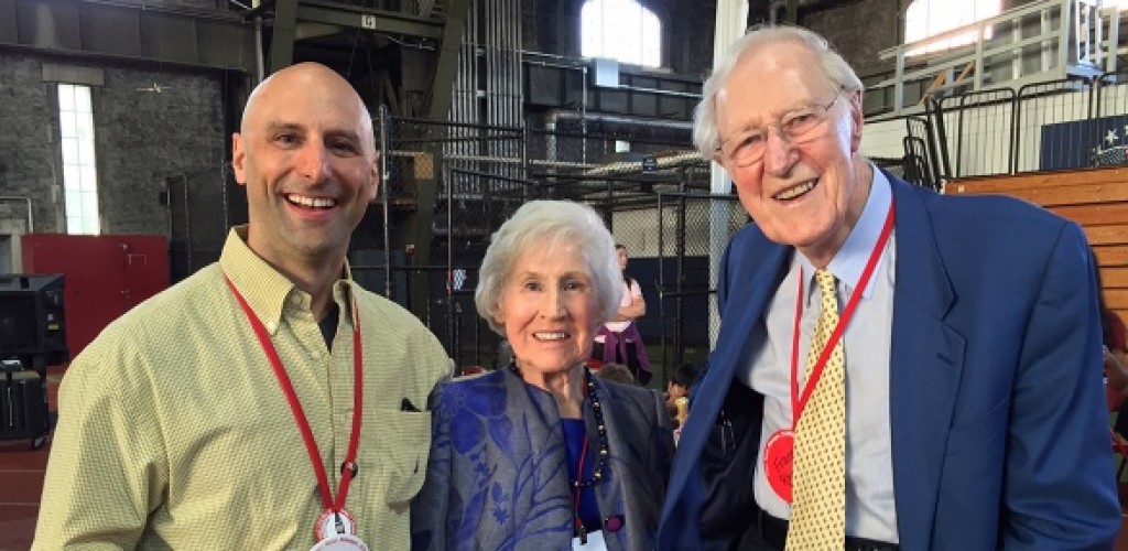 Two men and a woman stand together for a photo