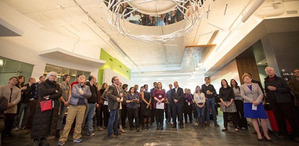 A crowd of people standing in a large room