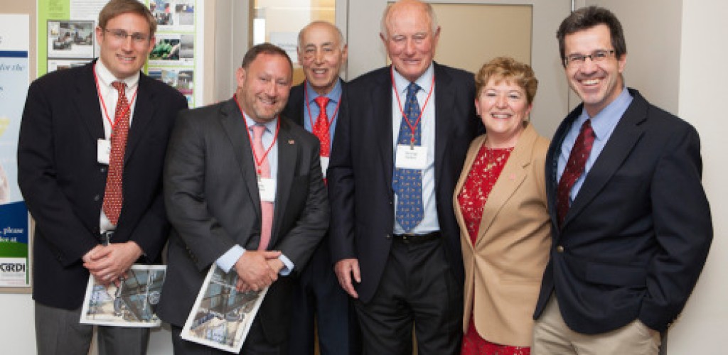 A group of people pose in front of a door